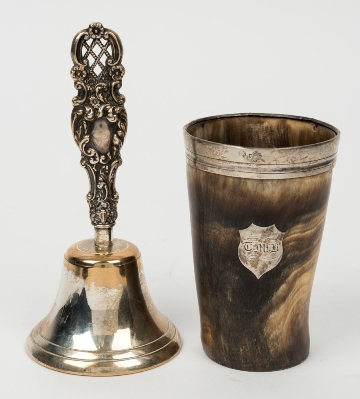 A sterling silver handled table bell, together with a silver mounted horn beaker with glass bottom, 19th century, (2 items), the bell 15.5cm high