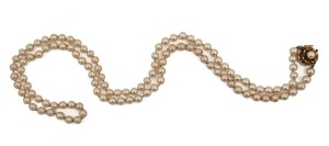 A cultured pearl necklace with 14ct gold clasp, set with blue sapphires and pearl, stamped "14k", 90cm long