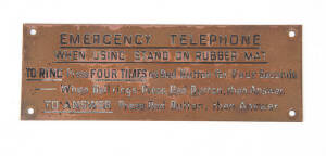 Railway or tramway sign: &ldquo;EMERGENCY TELEPHONE. WHEN USING STAND ON RUBBER MAT. TO RING Press four times on Red Button for Four Seconds &ndash; When Bell rings &ndash; Press Red Button, then Answer. TO ANSWER Press Red Button, then answer.&rdquo; Black lettering on brass, 5