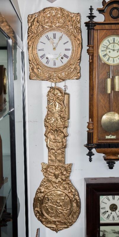 Comtoise antique French clock with enamel dial, 19th century, with pressed brass automata style pendulum and a pair of brass cased 18th century London long case weights, 149cm high overall