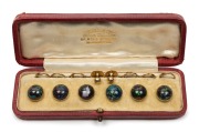 A fine set of boulder opal buttons and studs, mounted in 9ct yellow gold, housed in original plush box, circa 1900, ​​​​​​​the box 12.5cm wide