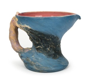 PHILIPPA JAMES pottery jug with windswept tree decoration, glazed in blue with pink interior, incised "Philippa James" 14.5cm high, 19cm wide