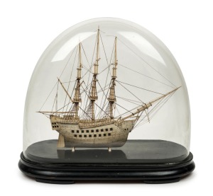 A Napoleonic prisoner of war bone model tallship housed in glass dome with base, early 19th century, the ship 35cm high, 40cm long, 44cm high overall