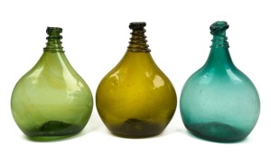 Three antique glass saddle flasks, 17th/18th century, ​​​​​​​the largest 31cm high