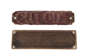 Carriage sign: &ldquo;SMOKING PERMITTED IN THIS COMPARTMENT ONLY BY MUTUAL CONSENT OF THE OCCUPANTS&rdquo;. Embossed brass, 5.5 x 18.5cm. Also, loco cab sign: &ldquo;CUT OUT&rdquo;, embossed red on red metal, 4.5 x 18.5cm. (2 signs)