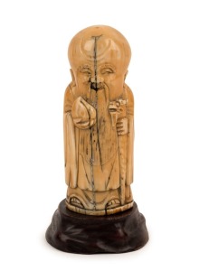 A Chinese carved mammoth ivory statue of a Sage with a peach and staff, in the Ming style, 11cm high