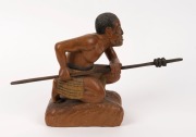 A carved statue of a crouching Maori warrior with taiaha and full Tā moko, 20th century, 20.1cm high - 3