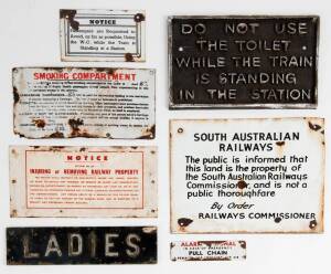 SIGNS: Group of 7 enamel tin & assorted metal signs including "LADIES"; "Do Not Use The Toilet While The Train Is Standing In The Station"; & "South Australian Railways". Varying sizes.