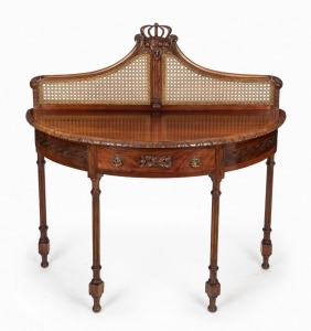 An antique Australian demi-lune side table with rattan back and attractively carved with gumnuts and leaves, early 20th century, ​​​​​​​115cm high, 114cm wide, 50cm deep