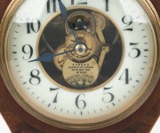 MANLY INTEREST: EUREKA CLOCK Co. antique English mantle clock in mahogany balloon case with marquetry inlay in the Sheraton manner, three ball bearing movement with electric coil and balance wheel, white glass chapter ring with Arabic numerals with expose - 3