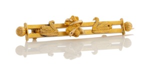 An antique Western Australian goldfield's bar brooch adorned with two swans and a gold nugget specimen, housed in a CARIS BROS. box, 19th/20th century, maker's marks illegible, 5.5cm wide, 6.5 grams