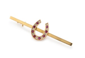 An antique 18ct yellow gold horseshoe stockpin brooch, set with rubies and diamonds, 19th century, stamped "18ct", 5.6cm wide, 4.8 grams