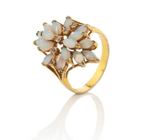 An 18ct yellow gold cocktail ring, set with sixteen polished solid opals and a row of five brilliant cut white diamonds, 4.6 grams