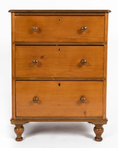 An Australian kauri pine three-drawer bedside chest, 71cm high, 53cm wide, 39cm deep.