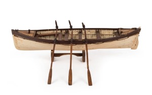 A scratch built model whaling boat with oars, 42cm long