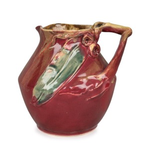 REMUED pottery vase with applied gumnuts, branch handle and leaf, glazed in rare deep pink and green colourway, incised "Remued", 16cm high