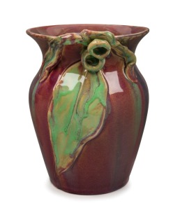 REMUED pottery vase, beautifully modeled with large gumnuts, gum leaf and associated branches, glazed in pink, mauve and lime green, almost certainly the work of MARGARET KERR, incised "Remued", 19cm high