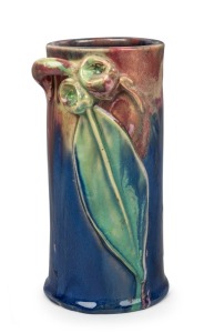 REMUED pottery cylindrical vase with applied gumnuts, branch handle and leaf, glazed in pink, blue and green, incised "Remued, Hand Made, 145/6M", 17cm high