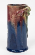 REMUED pottery cylindrical vase with applied gumnuts, branch handle and leaf, glazed in pink, blue and green, incised "Remued, Hand Made, 145/6M", 17cm high - 2