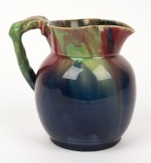 REMUED pottery jug with applied gumnuts, branch handle and leaf, glazed in pink, blue and green, incised "Remued", 15cm high - 4