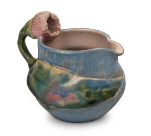 PHILIPPA JAMES pottery jug with gum blossom handle and applied leaf decoration, glazed in pink, blue and green, incised "Philippa James" 7.5cm high, 9cm wide