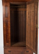 An Australian solid fiddleback blackwood wardrobe with arch-top bevelled mirror door, base drawer and Art Nouveau copper strap hinges, circa 1915. Note: two piece unit. 201cm high, 119cm wide, 53.5cm deep - 2