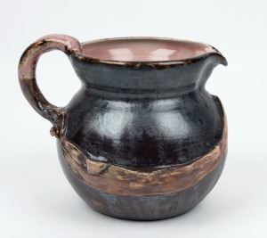 PHILIPPA JAMES brown glazed pottery jug  with pink interior, adorned with gumnuts and leaf with branch handle, incised "Philippa James" ​​​​​​, 14cm high, 17.5cm wide