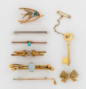Eight antique bar brooches, comprising a key brooch by JOSEPH LAWRENCE of Melbourne, a South Australian bow brooch, a golf stick, a white opal, a wishbone and swallow plus three others, 9ct and 15ct gold as well as platinum topped&nbsp;example, circa 1900, ​​​