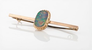 An antique 9ct rose gold brooch, set with solid polished opal, housed in Otto Fuchs box from Grafton, New South Wales, 19th/20th century, 4.7cm wide, 2 grams total