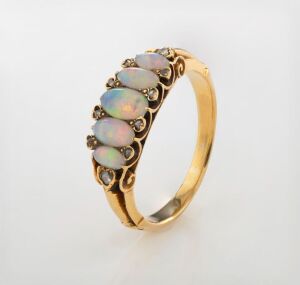 An antique yellow gold ring, set with five graduated polished solid opals interspersed with white diamonds, 19th/20th century