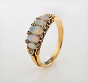 An antique yellow gold ring, set with five graduated polished solid opals interspersed with white diamonds, 19th/20th century