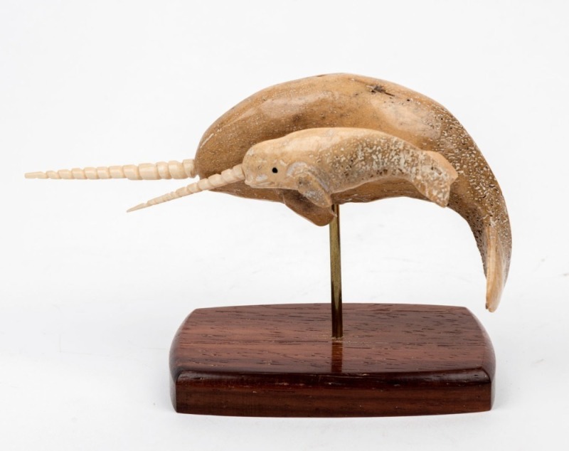 A carved whalebone narwhal figure group on wooden stand, 14.5cm wide