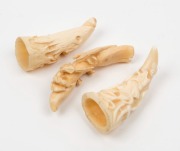 Three whales tooth ornaments, all carved in deep relief, the largest 8cm high - 2