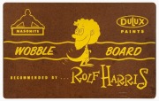 A pair of Masonite/ Dulux Paints branded Wobble Boards, "recommended by Rolf Harris" one with a number of music related labels fixed. 38cm wide, 61cm long. - 3