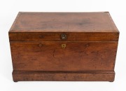 An antique Australian cedar flip-top trunk with string and barber pole cross-banding,&nbsp;moulded plinth base and recessed brass hardware, 19th century, 48.5cm high, 88cm wide, 48.5cm deep