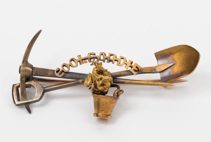 "COOLGARDIE" 15ct gold brooch with crossed pick and shovel, bucket and gold nugget specimen, applied lozenge mark ​​​​​​​stamped 15ct with pictorial marks, ​​​​​​​4.4cm wide