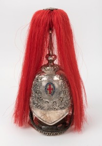 A presentation electro plated silver model of a Calvary helmet of The royal Horse Guards, the helmet with leather backed chain scales and enameled garter below a red plume, circa 1900, 33cm high