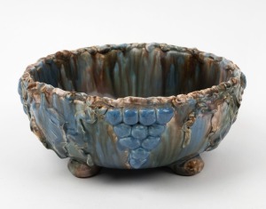 ARTIST UNKNOWN hand-built pottery fruit bowl with applied grapes and leaves, glazed in MASHMAN style finish and colourway, incised on the base (illegible), ​​​​​​​10cm high, 23cm wide