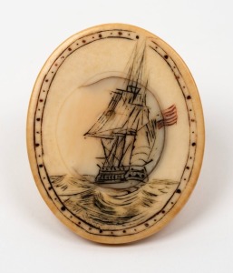 A scrimshaw whalebone toggle depicting an American ship under full sail, 19th century, 5cm high