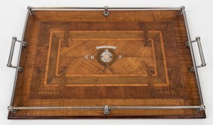 An antique Australian specimen timber marquetry serving tray with metal gallery, presented as a prize with sterling silver and rose gold plaques "THE BEST AND FAIREST, WON BY S.B.F." (South Brisbane Football Club?), Queensland origin, early 20th century, 