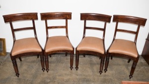 A set of four Australian cedar spade back dining chairs with tapering hexagonal form front legs, sabre rear legs and crinoline front rail, circa 1840