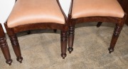 A set of four Australian cedar spade back dining chairs with tapering hexagonal form front legs, sabre rear legs and crinoline front rail, circa 1840 - 5