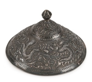 An antique Vietnamese silver conical shaped military hat badge, decorated with dragons, insects, birds and human figures, 19th century, 7cm high, 11.5cm diameter