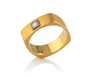 An 18ct yellow gold Modernist ring set with a brilliant cut diamond in white gold mount, stamped "750", an impressive 15.5 grams