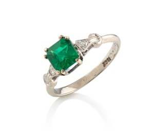 An 18ct white gold ring, set with a stunning natural cut emerald, flanked by brilliant cut white diamonds, with accompanying valuation ($8,200), 2.6 grams total