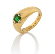 An 18ct yellow gold gent's ring, set with a square cut emerald surrounded by four white diamonds, 4.6 grams