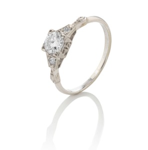 An 18ct white gold ring, set with a fine quality cut white diamond (approx. 0.5ct) flanked by a pair of diamonds, 2.4 grams
