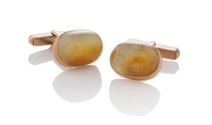 An antique pair of polished Russian jade cufflinks, set in 14ct rose gold, 19th century, stamped "14K",