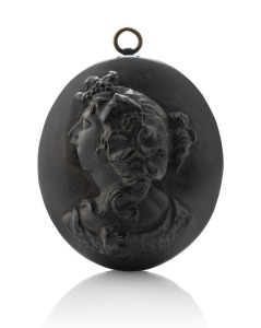 An antique jet locket with cameo profile portrait of a lady, the interior handsomely carved with scrolling motif, circa 1860s, ​​​​​​​4.5cm high