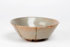 A Korean celadon bowl, Koryo/Yi Dynasty, 14th/15th century, four firing marks in the centre, a good bluish green glaze, an unusual V shaped section on the foot rim, two gold lacquer repairs. 15.5cm diameter